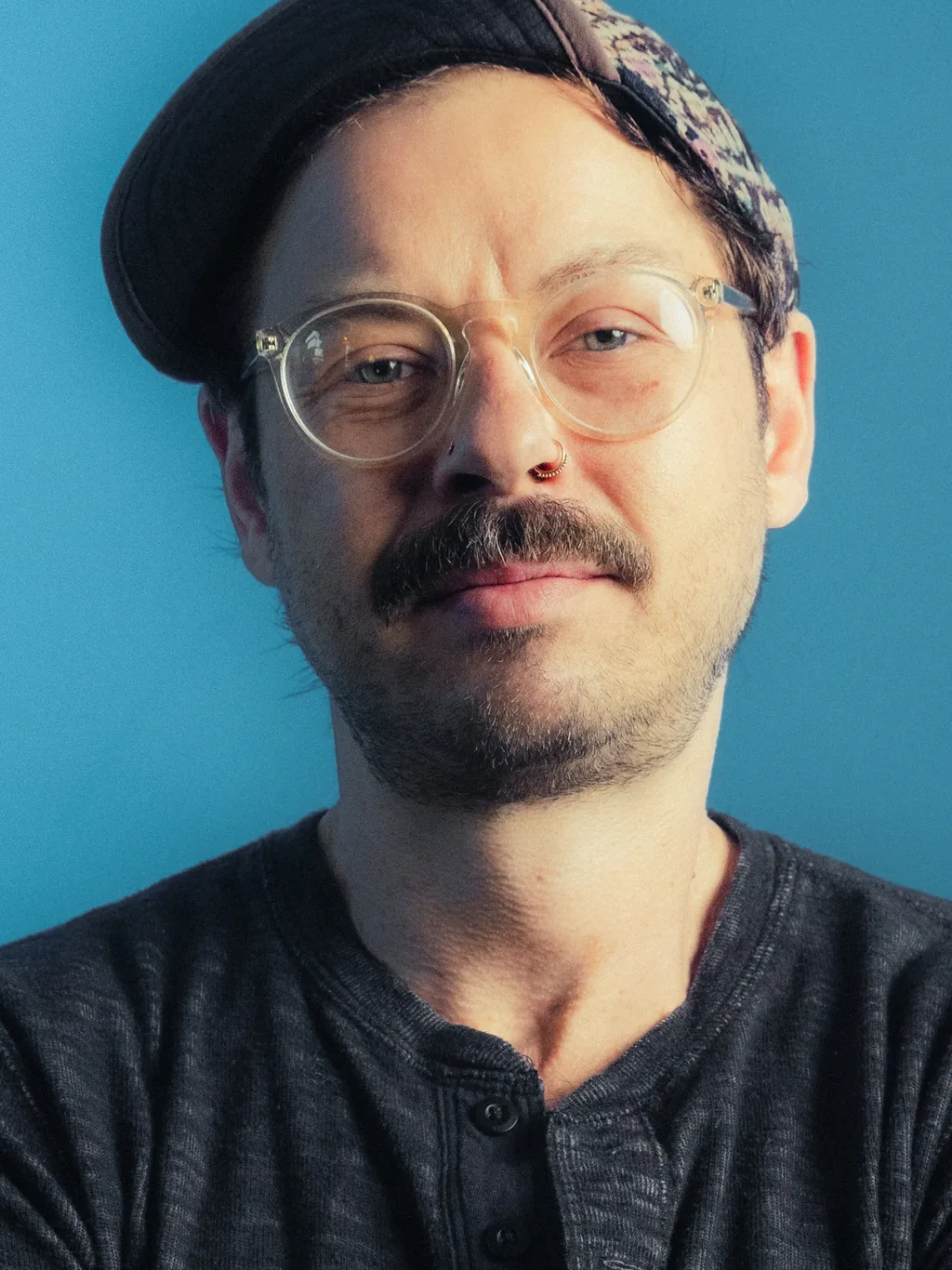 Creative collaborator photographed against a blue background