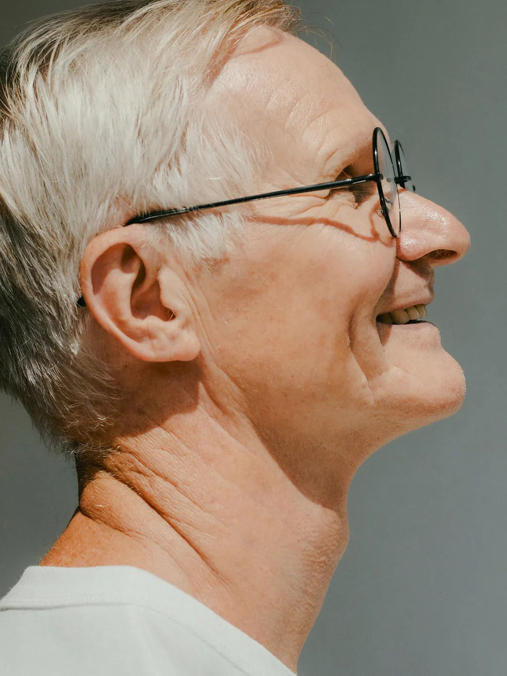 An older woman smiling in profile
